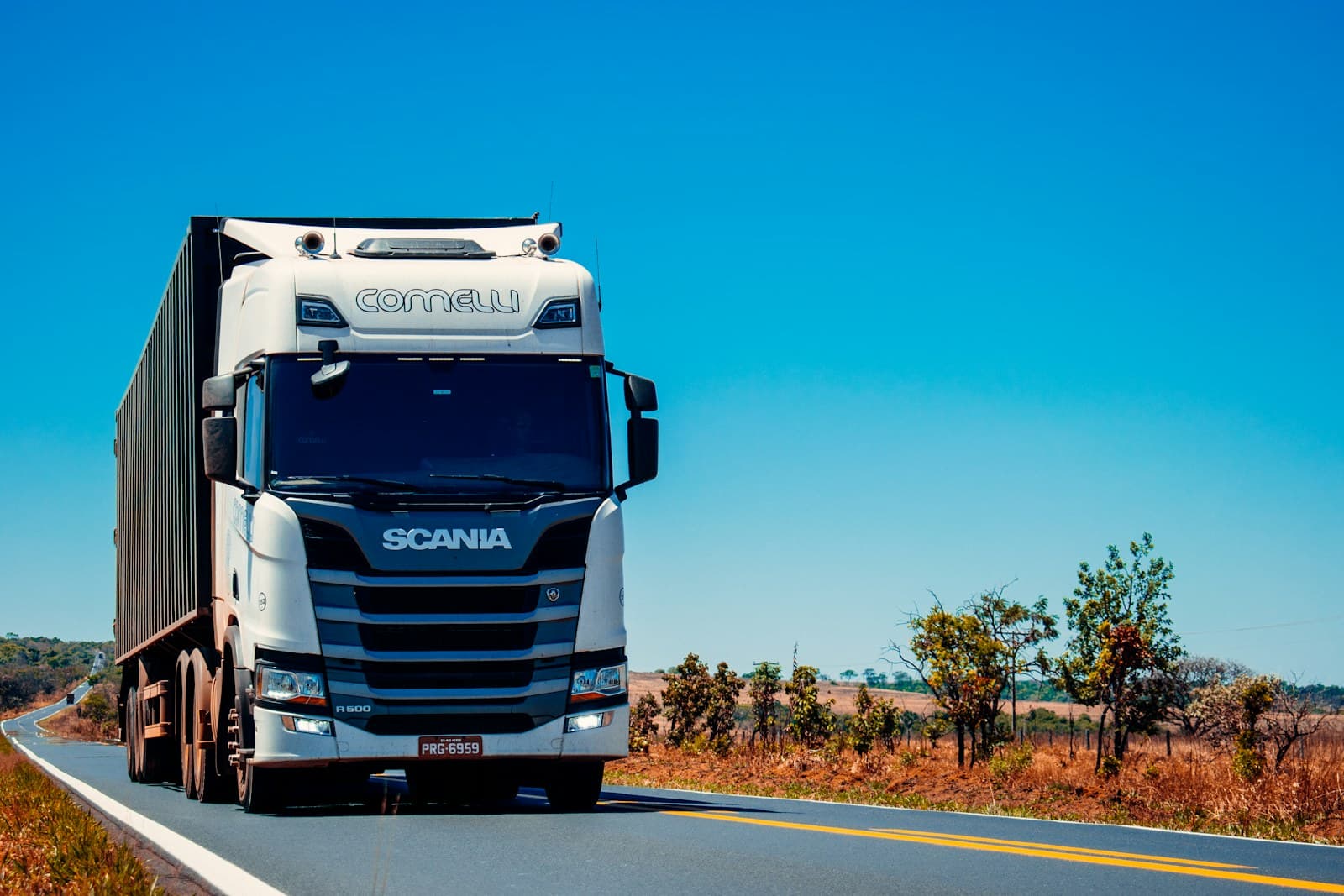 Long-haul freight truck moving through a rural logistics lane